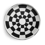 Black and white checkerboard glaze pattern on a low, round porcelain platter.