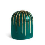 Dark green cylinder candle posed from side to show gold drip details from eye motif
