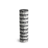 A handmade porcelain vase with indigo dye drops to flowing down from the rim.