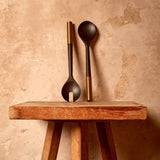 Alhambra Serving Set (2 Piece Set). hand-carved, fine smoked ash serving utencils with brass ring details.
