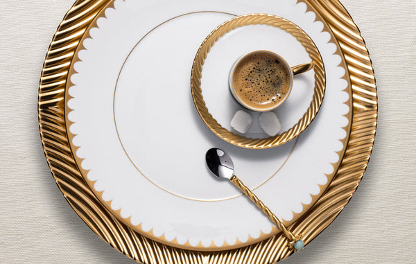 Porcelain Corde charger plate with gold arched strand motif, Aegean Filet dinner plate with gold scalloped border, Corde gold espresso cup with saucer.