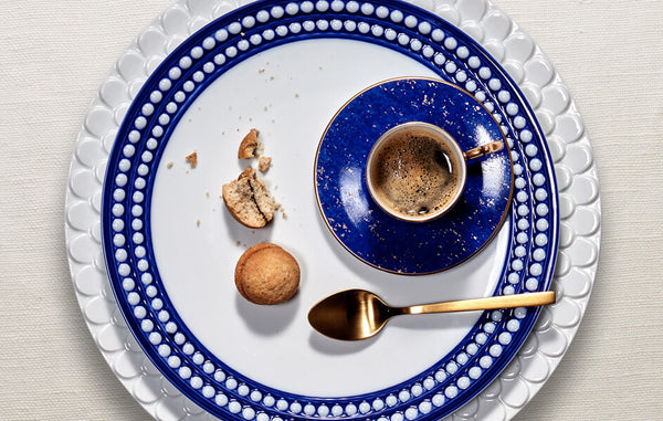 Aegean white charger plate with wave motif border, Perlee white and blue porcelain dinner plate, Lapis blue porcelain espresso cup and saucer.