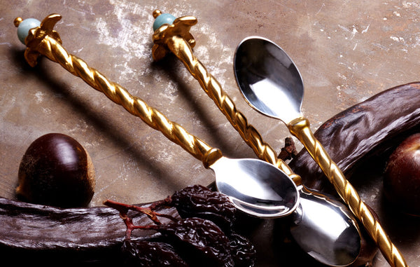 Cocktail spoons with twisted gold handles and blue stone embellishments.
