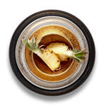 Black, platinum and gold glazed Alchimie plates with cut pineapple.