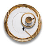 Porcelain Corde charger plate with gold arched strand motif, Aegean Filet dinner plate with gold scalloped border.