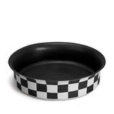  Black and white checkerboard glaze pattern on a low, round porcelain bowl with a flared rim shape. 