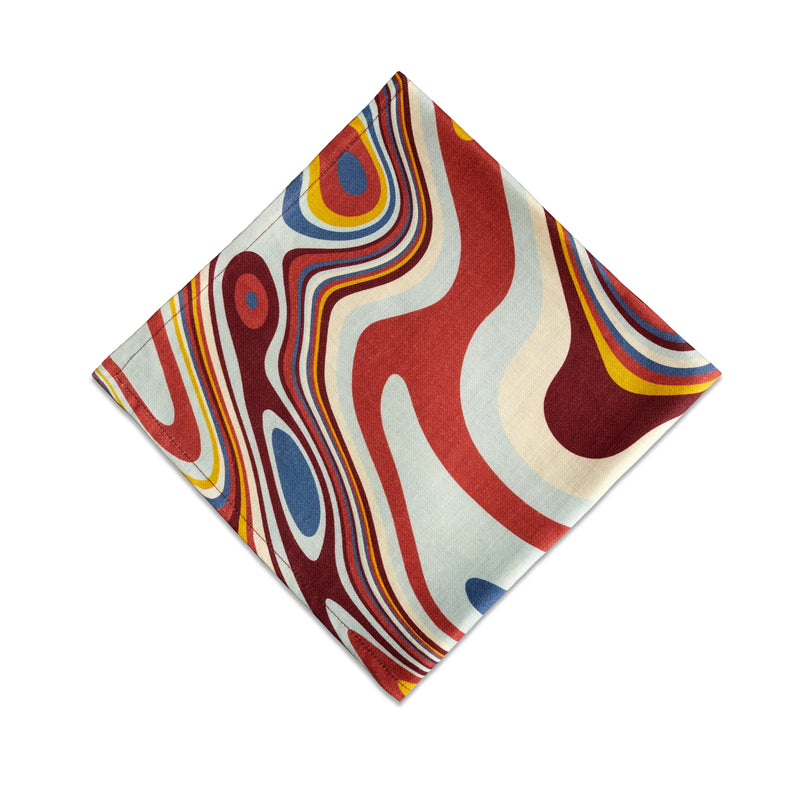 Linen napkins with an organic, psychedelic pattern in red, blue, yellow and ivory hues.