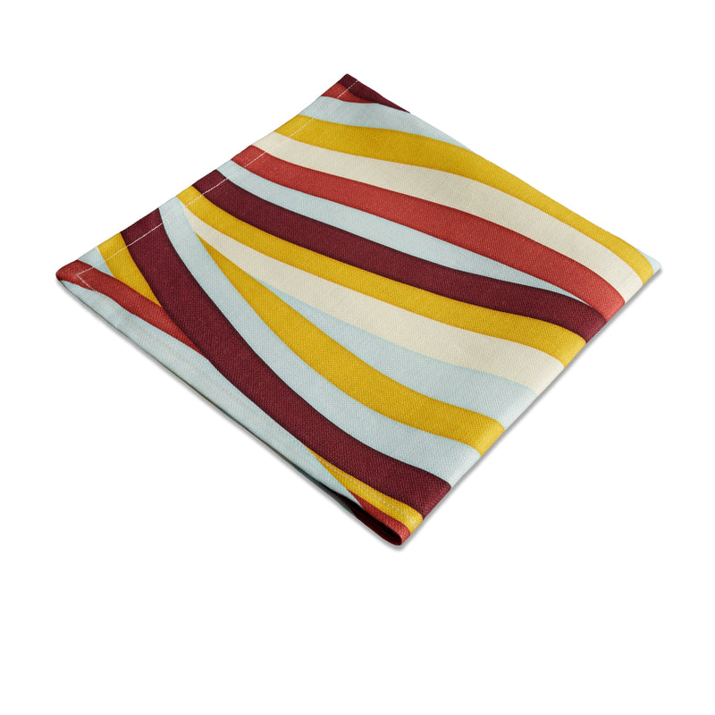 Linen napkins with an organic, undulating pattern in red, burgundy, blue, green and ivory hues.