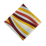 Linen napkins with an organic, undulating pattern in red, burgundy, blue, green and ivory hues.