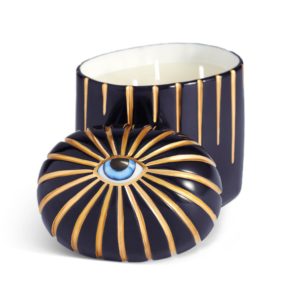 Dark blue cylinder candle with three wick posed with its eye motif topper
