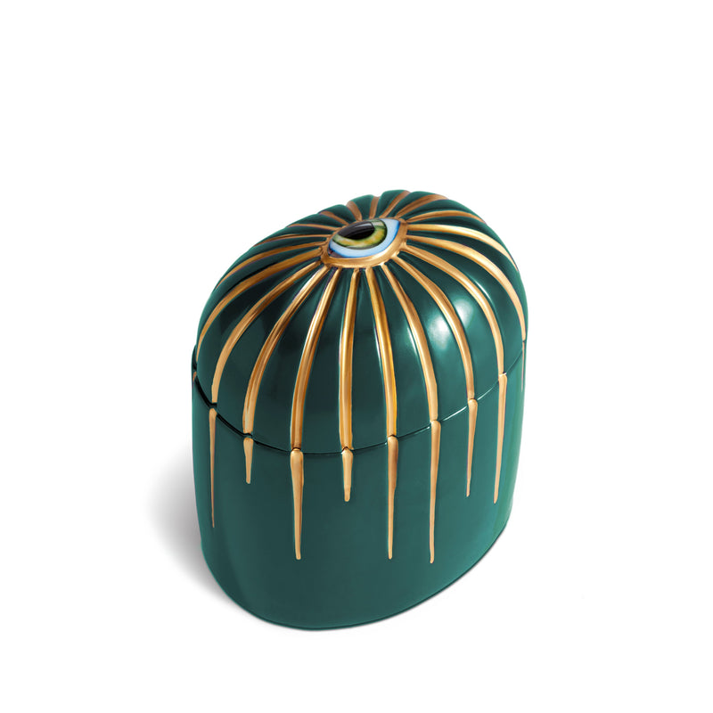 Dark green candle with gold details dripping from top eye motif
