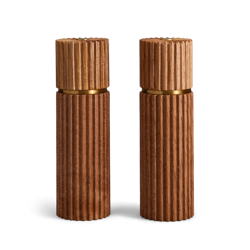 Architectural salt and pepper mills are hand carved in natural European oak with metal grinding mechanism