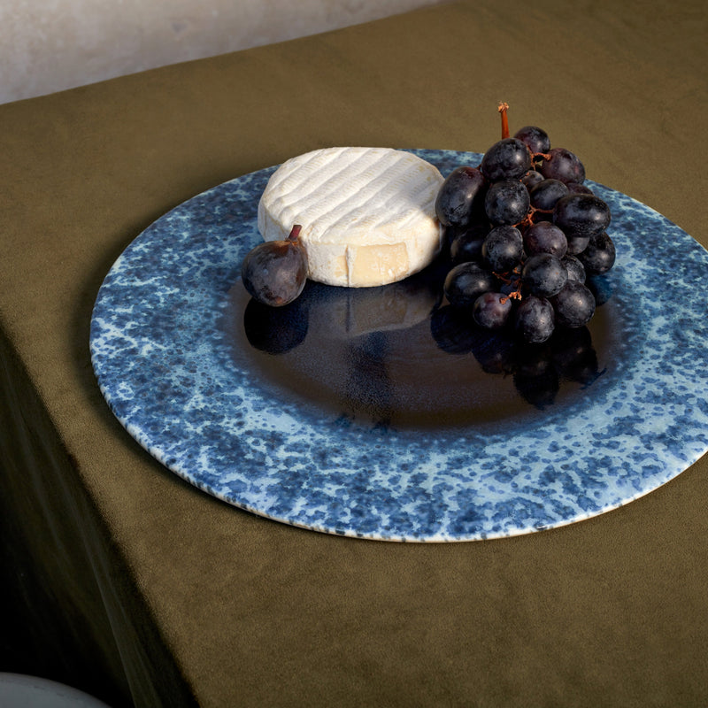 Blue round placemat with organic, irregular glaze