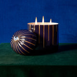 Lito Candle 3-wick lit up posed with eye motif topper