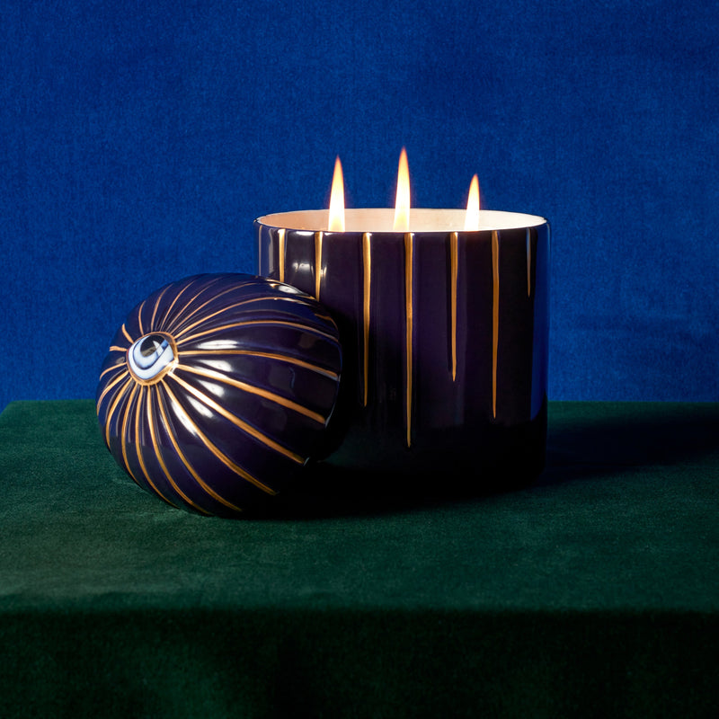 Lito Candle 3-wick lit up posed with eye motif topper